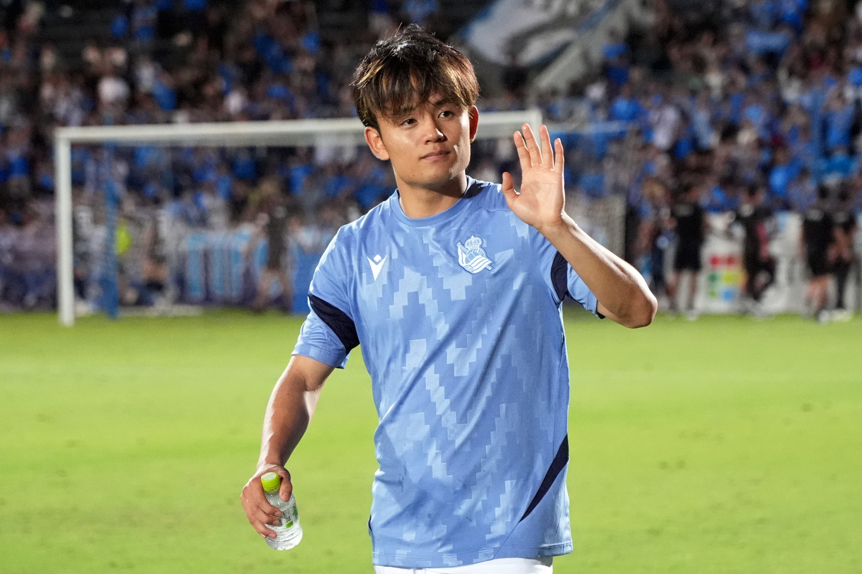Takefusa Kubo waves at fans