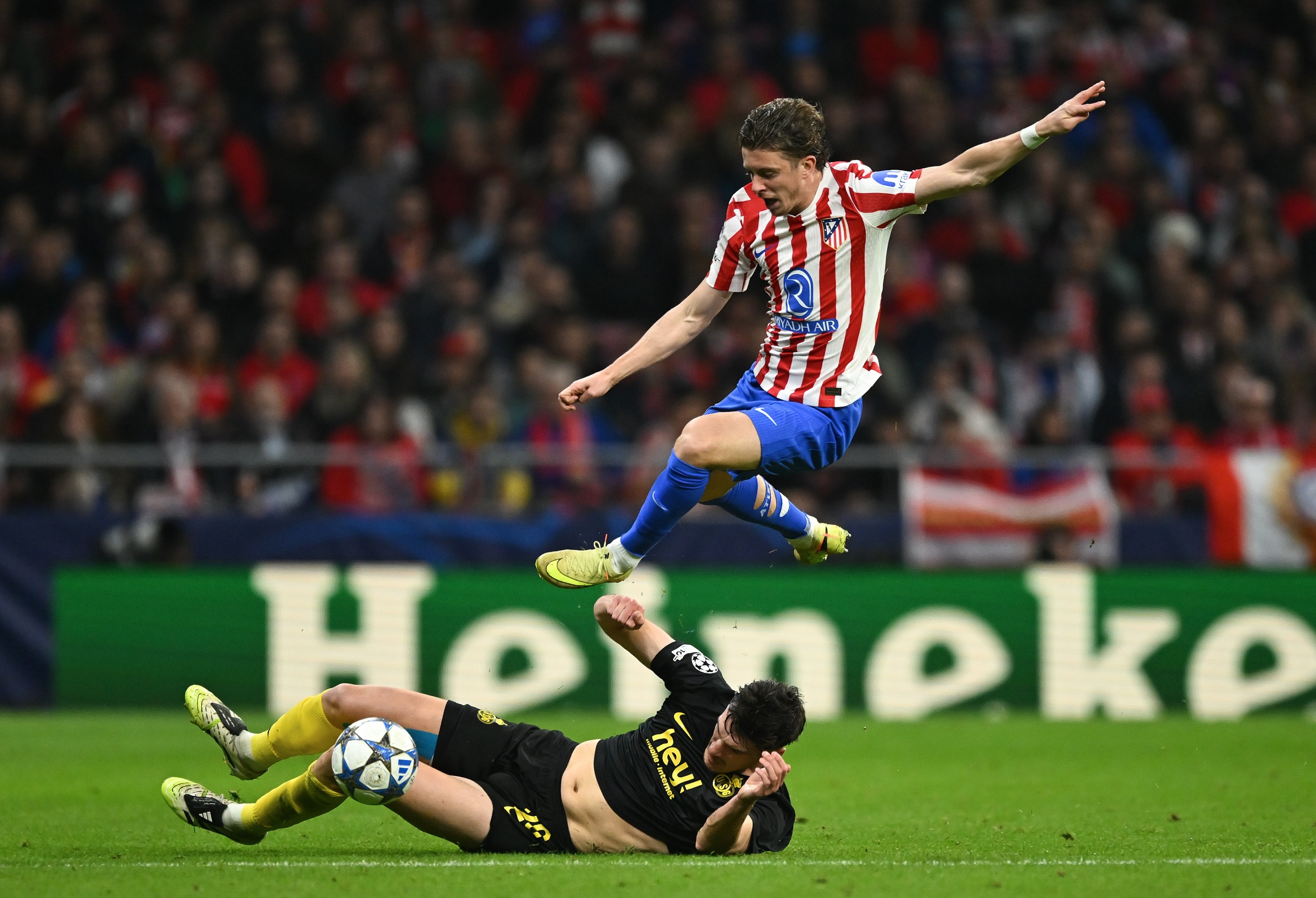 Conor Gallagher of Atletico Madrid is tackled by Ross Sykes of R. Union Saint-Gilloise