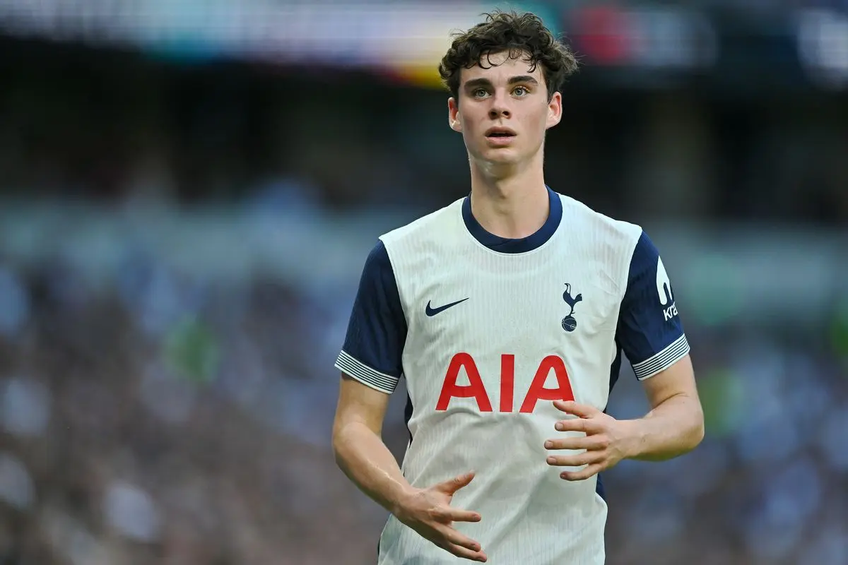 Archie Gray wearing a white Tottenham Hotspur home kit during a match