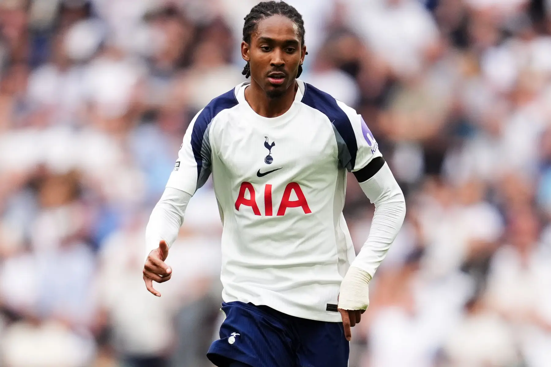 Djed Spence in a Tottenham Hotspur jersey during a match.