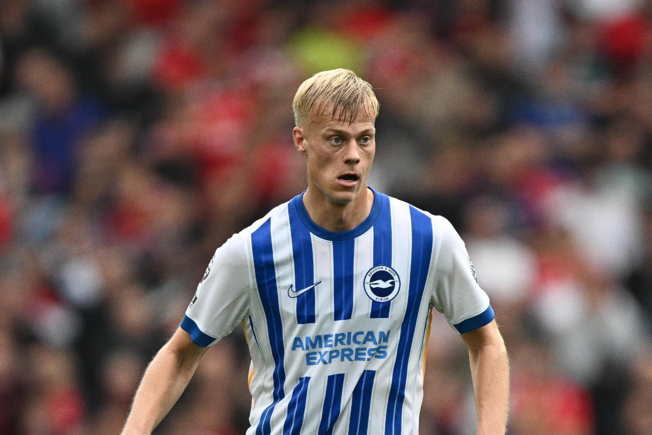 Jan Paul van Hecke in a Brighton & Hove Albion soccer kit on the field.