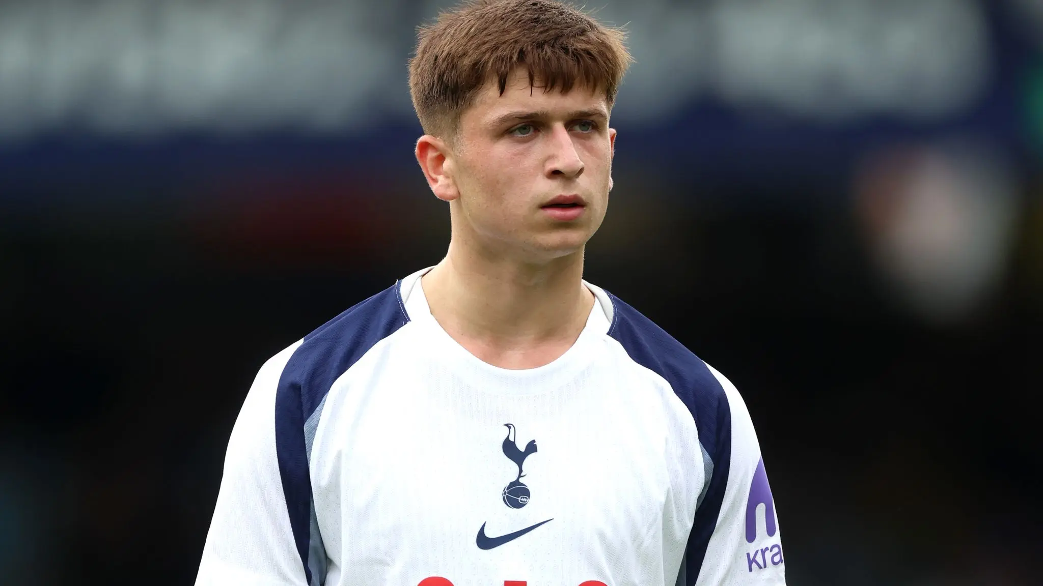 Portrait of Mikey Moore wearing a white Tottenham Hotspur football kit