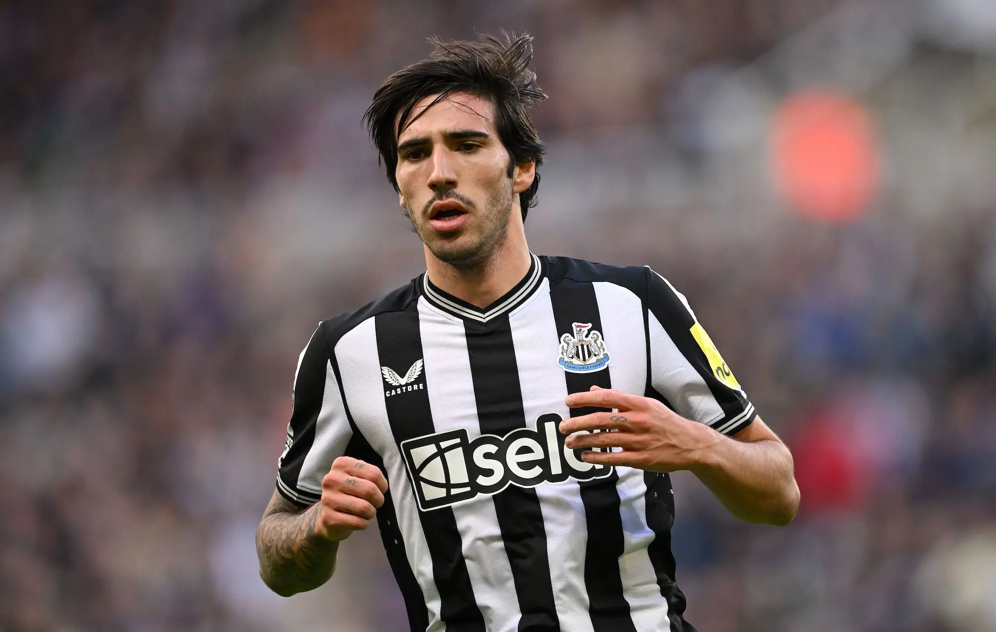 Sandro Tonali in a Newcastle United jersey during a match.