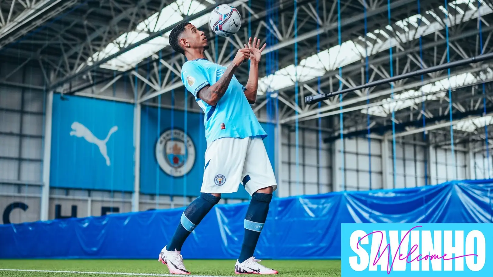 Savinho, Manchester City winger, skillfully juggling a soccer ball indoors.