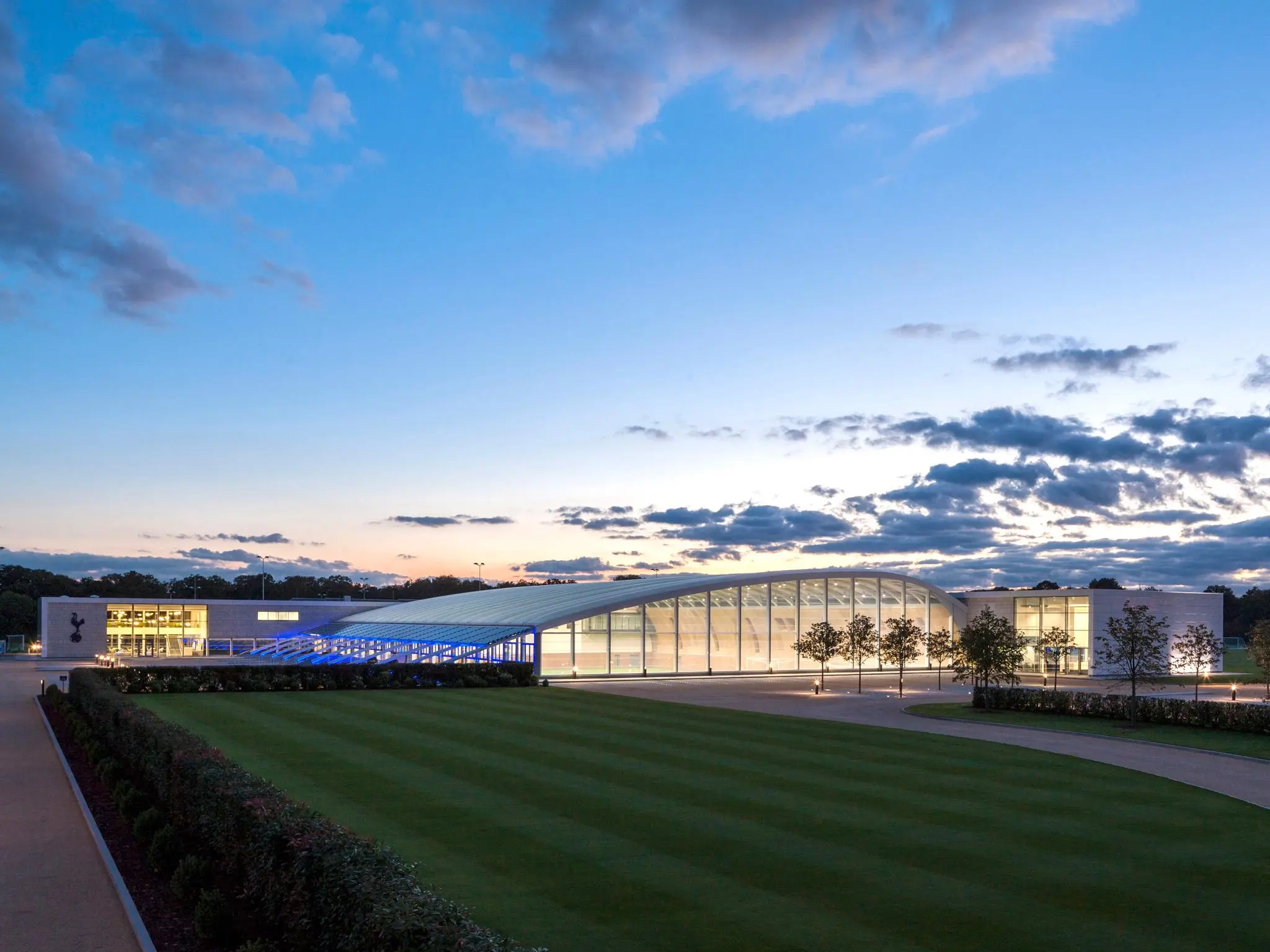 Exterior view of Tottenham Hotspur Academy training ground at dusk.