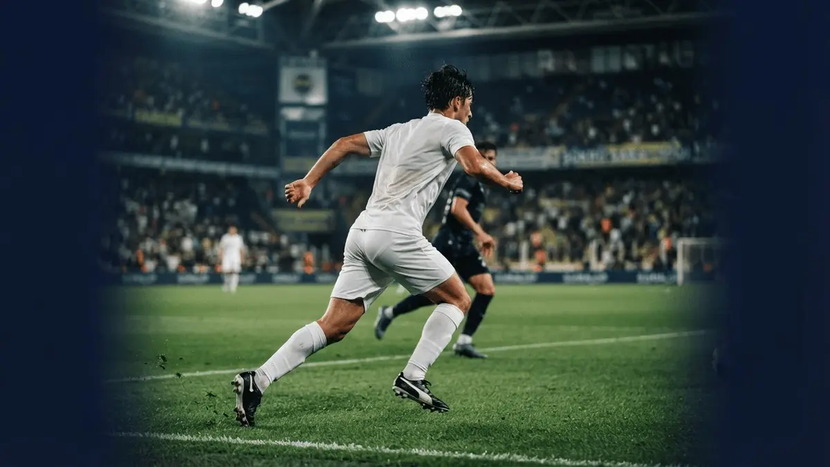Young defensive midfielder pressing on a football pitch under stadium lights