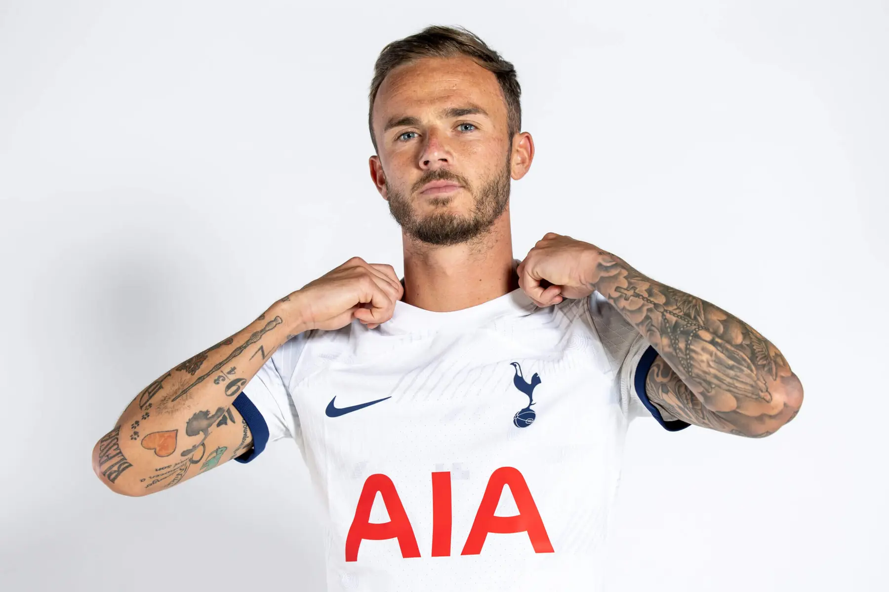 James Maddison wearing a white Tottenham Hotspur home kit with AIA sponsor logo