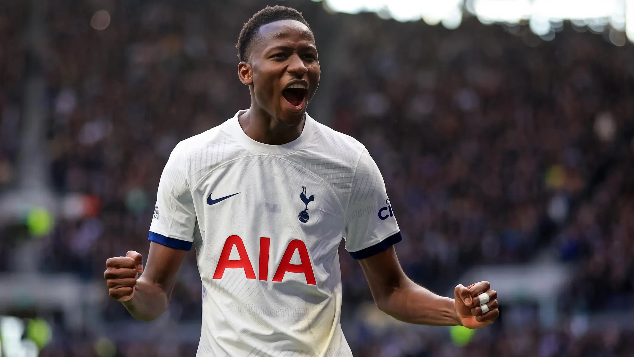 Pape Matar Sarr celebrating in a white Tottenham Hotspur home kit during a match