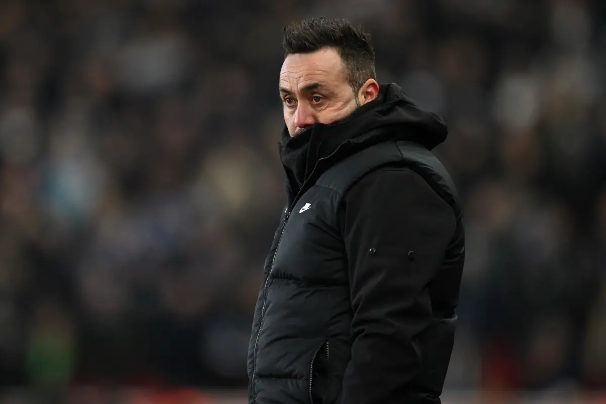 Roberto De Zerbi wearing a black Nike puffer jacket on the touchline during a football match