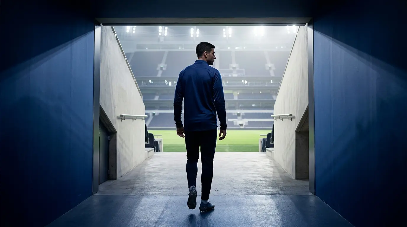 Anonymous footballer silhouette in a navy stadium tunnel representing Marmoush's potential Tottenham loan transfer
