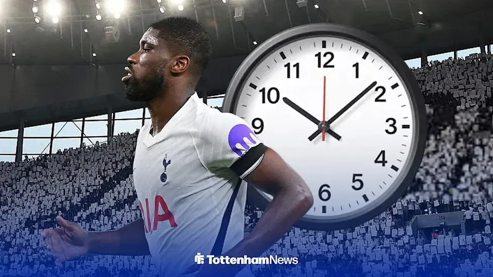 Tottenham Hotspur player in white home kit with a large analog clock overlay and stadium background