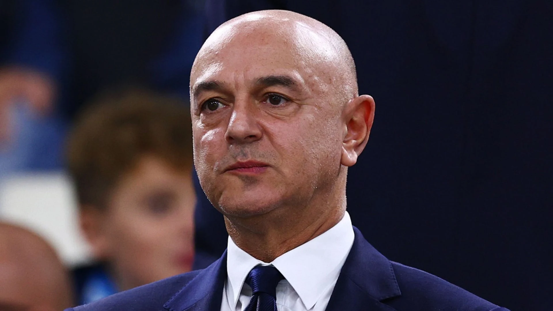 Portrait of Daniel Levy wearing a navy suit and tie
