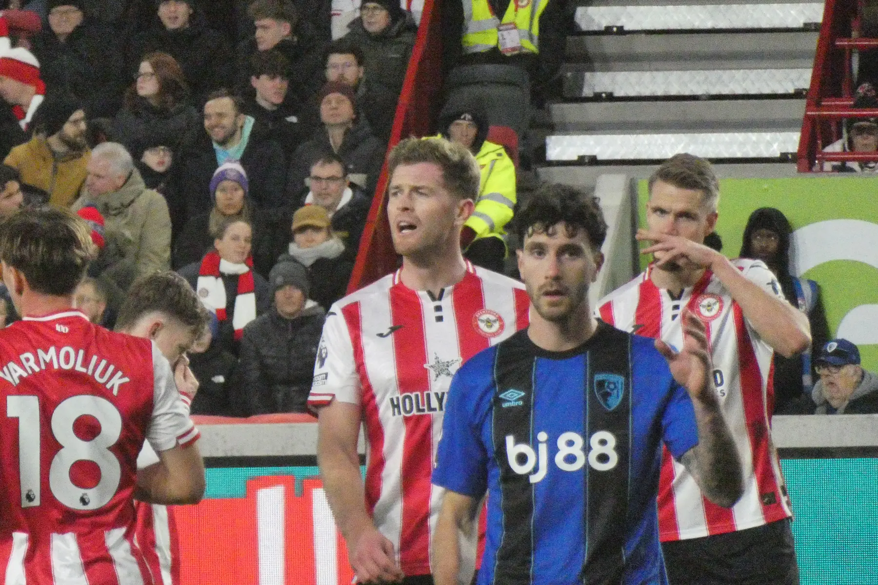 Marcos Senesi in a red and white striped kit during a football match.